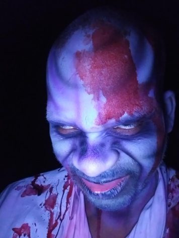 Brian Spight poses after getting his makeup sprayed on, preparing for a night of scaring at HUSH Haunted Attractions. “It only takes around 15 minutes and the makeup artists are always willing to try new things,” Spight said.