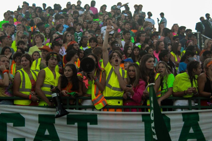 On+the+stands+at+the+football+field%2C+the+student+section+dons+neon+clothes+as+they+cheer.+Senior+Beau+Odonnell+raises+his+fist+in+the+air%2C+praising+the+team.