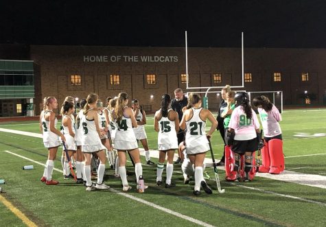 In the Wildcat stadium, the girls repping green and white jerseys gather in a circle and listen to their coaches’ advice on improving their game play on the last home game of the season.