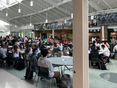 Students mill about the cafeteria during A lunch.