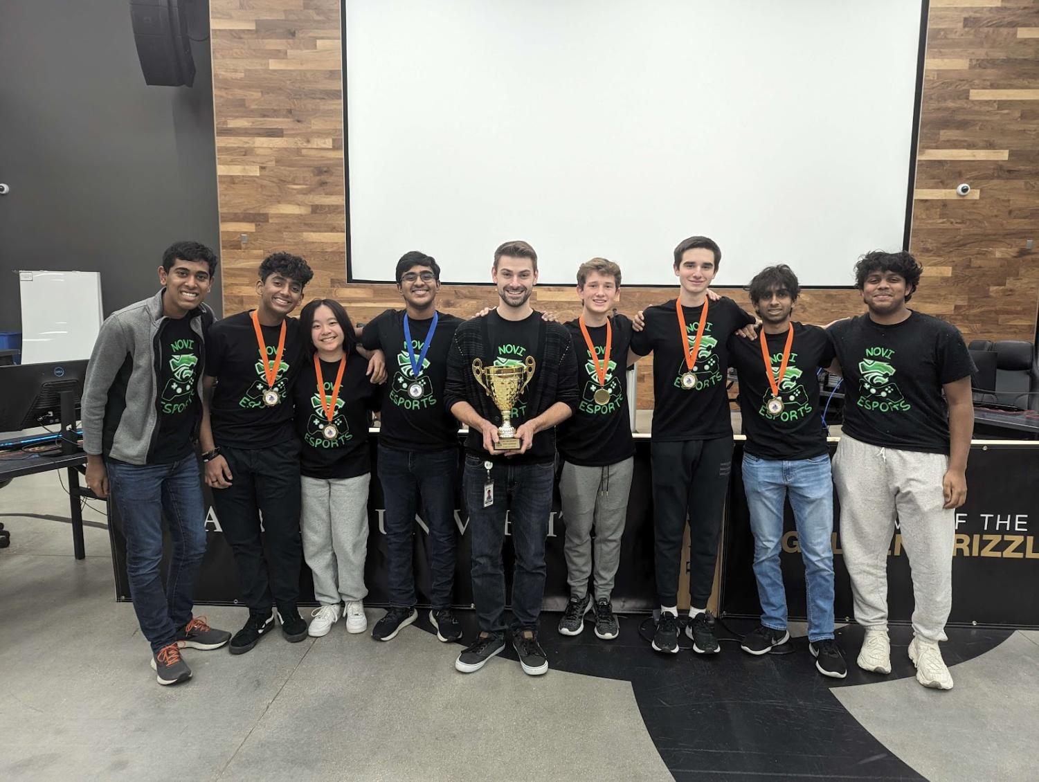 The League of Legends team celebrates their state finals victory in the fall season with some of the Smash Bros Green team. December 10th, 2022, Oakland University. From left to right: Rishi Tappeta, William Diaz, Julia Lin, Kavin Kukunoor, Christopher White, Conner Kirkman, Robert Floros, Nihal Dongari, Pranav Chinniah. Picture provided by Mr. White.