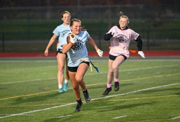 Junior wide receiver Michella Tortelli sprints past the senior Audrey Verbracken in the 2022 powderpuff game. Tortelli returns to lead the seniors  in their attempt to repeat as champions in the 2023 game.